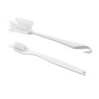 Cleaning brush with ergonomic handle on plain background