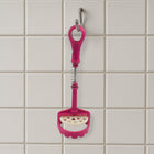 Easy-to-clean food-grade potato masher under running water.
