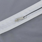 Closeup of durable full-length zipper on the breathable fabric suit cover.