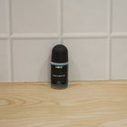 Blue AOE roll-on deodorant with label and cap attached