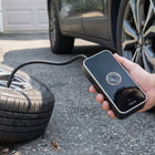 Air pump inflating car tyre outdoors with pressure nozzle