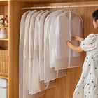 Woman efficiently organising her wardrobe using the suit covers for garment protection.
