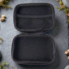 Open empty travel storage case showing interior compartments
