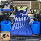 Blue inflatable car mattress on back seat with cushions for travel comfort
