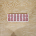 Pink ice cube tray in use for freezing