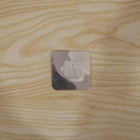 Self adhesive wall hook securely holding items in a home setting.
