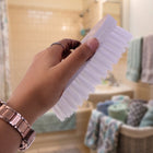 Durable plastic and nylon bristle cloth washing brush with ergonomic oval shape.